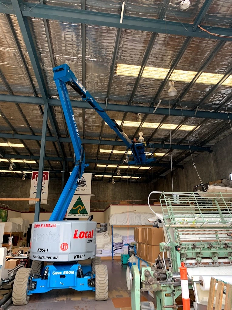 Commercial electrician at work in Ormeau, showcasing professional electrical installation in a commercial setting.